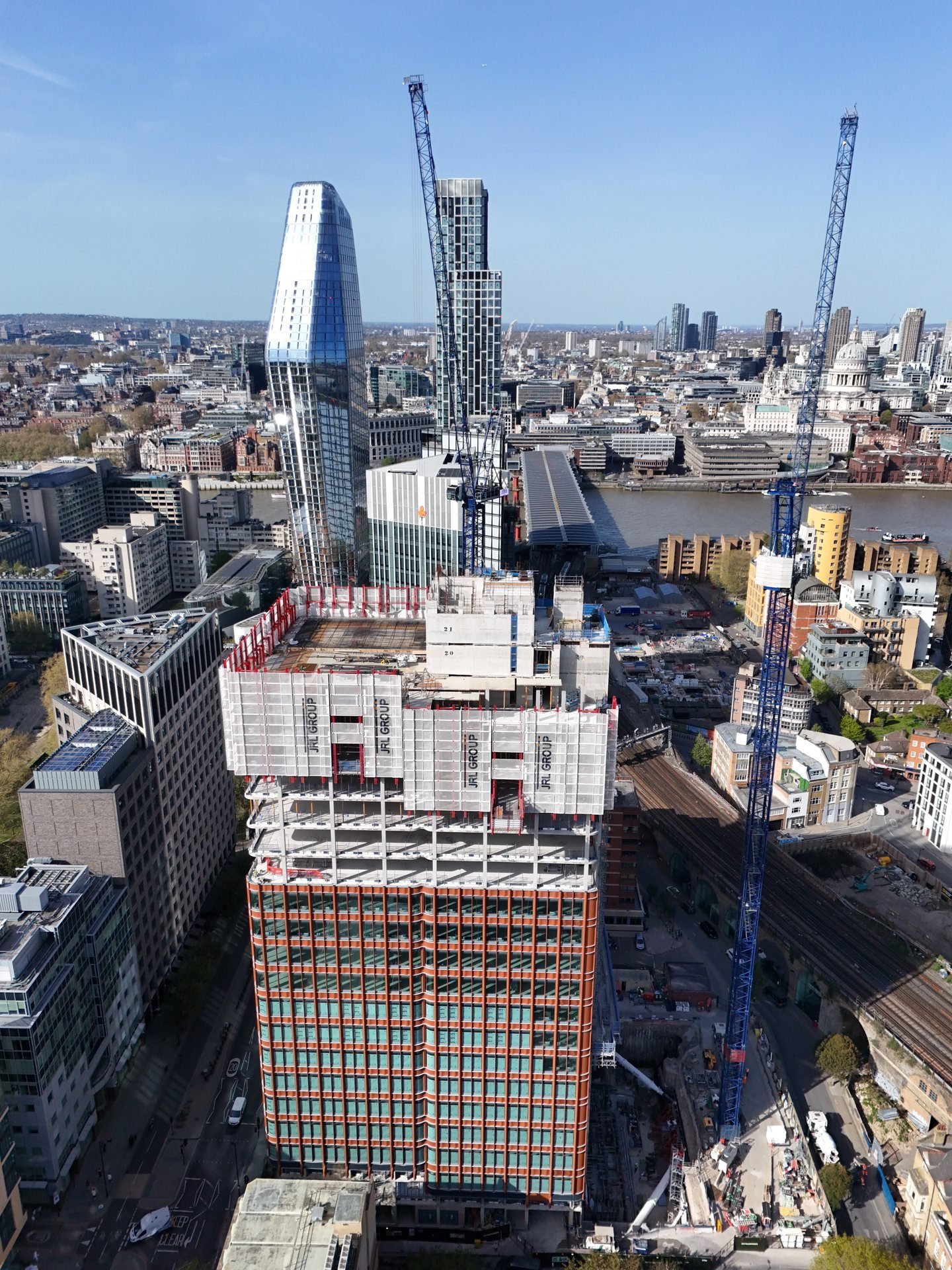 Portrait aerial view of 220 Blackfriars under construction with the London skyline behind it
