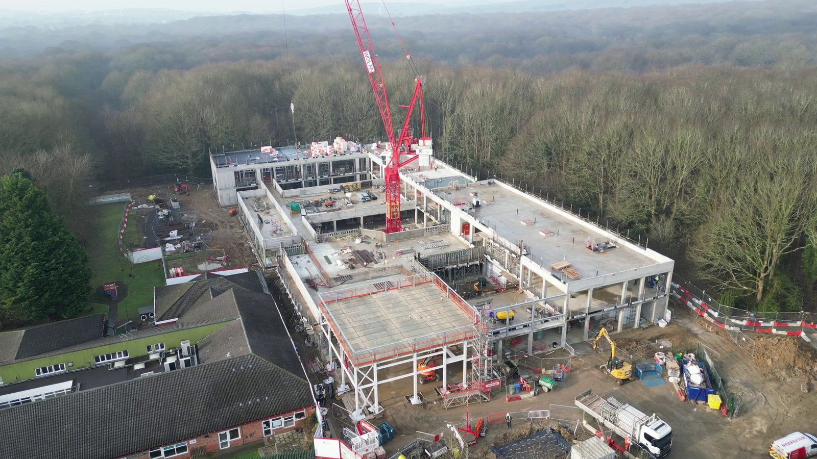 Crane and developing school structure documented during construction
