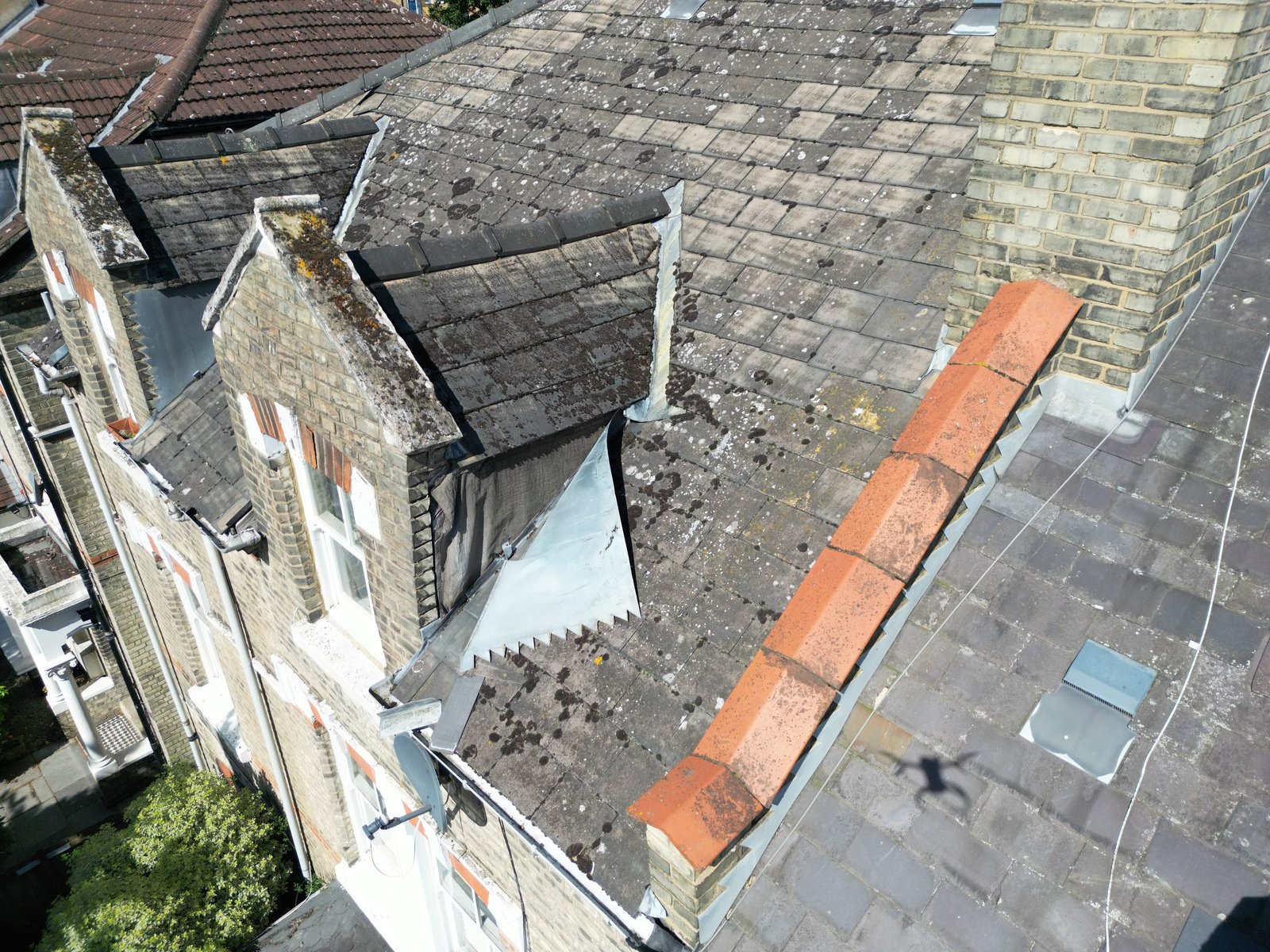 Detailed aerial view of roof coverings, chimneys and junctions