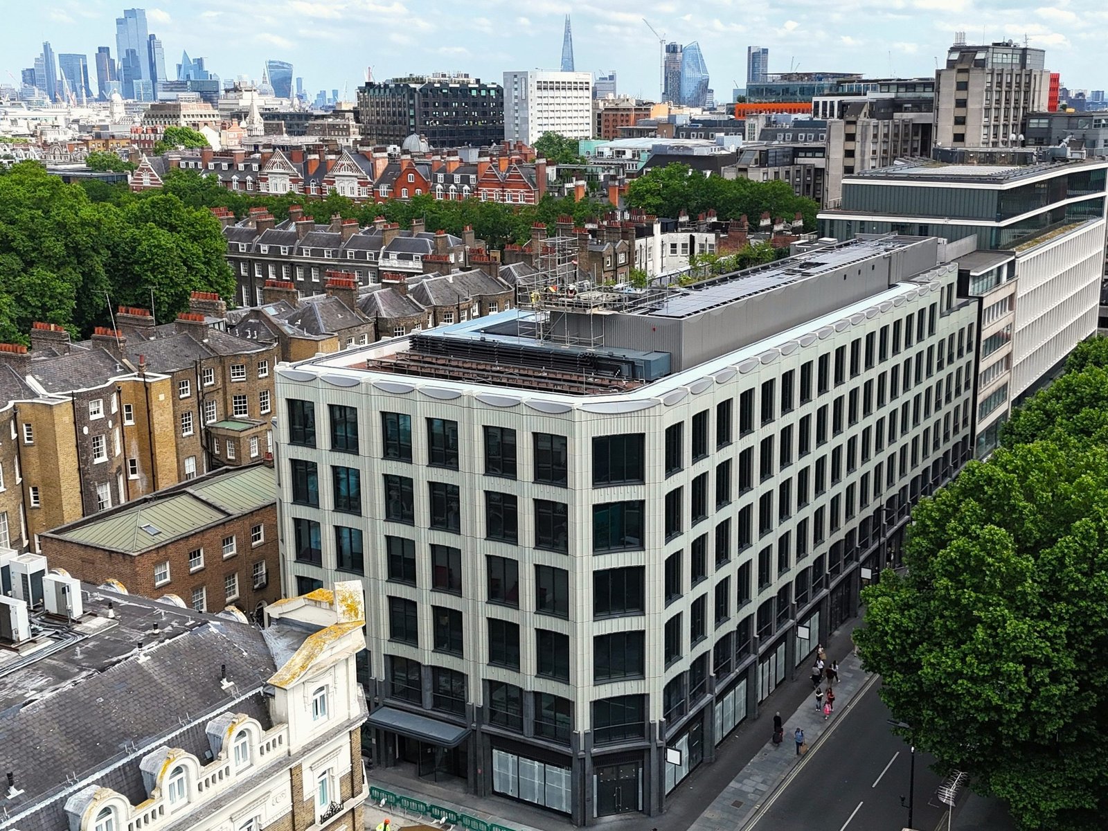 Aerial view of a completed London property with the city skyline beyond